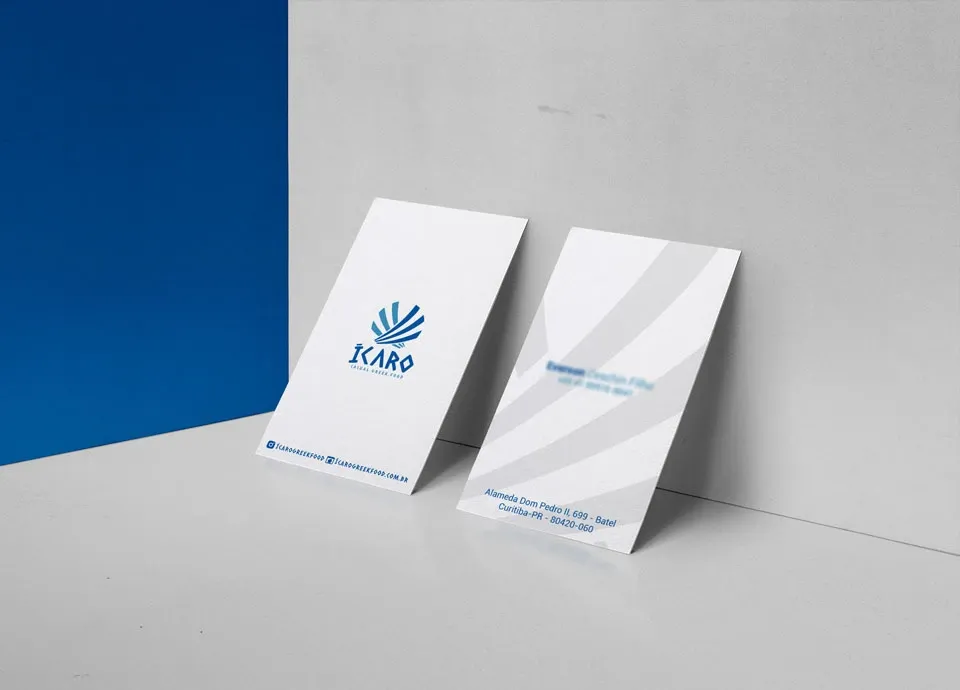 Ícaro's business card, front and back, in deep blue with the mark in white